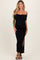 woman wearing a black off-shoulder maternity dress with a bow detail and a side slit, showcasing her baby bump