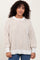 woman wearing a cream and beige striped oversized sweater with balloon sleeves and a ribbed hem