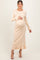 woman wearing a light beige ribbed maternity dress with ruffle hem and bell sleeves, holding her baby bump