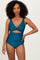 woman wearing a teal cutout one-piece swimsuit with a twist detail and high waist design