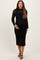 woman wearing a black lace long sleeve maternity dress and holding her baby bump