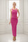 woman wearing a pink and white striped maxi dress with thin straps and a form-fitting silhouette