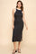 woman wearing a black ribbed midi dress with white neckline and side slit