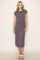 woman wearing a dark grey cap sleeve midi dress with side slits and standing on a plain background