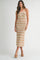 woman wearing a striped knit maxi dress in earthy tones with a halter neckline and side slit, posed standing