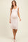 woman wearing a pink floral maternity dress with cap sleeves and a visible baby bump