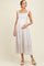 woman wearing a light floral print maternity maxi dress and holding her baby bump