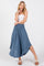 woman wearing a light blue maxi skirt with a smocked waistband and a fitted white tube top