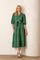 woman wearing a green tiered midi dress with puff sleeves, a button-down front, and a tie waist detail