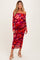 woman wearing a red floral off-the-shoulder maternity dress with ruched details and a visible baby bump