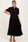 woman wearing a black tiered button-up maternity dress with short puff sleeves and a visible baby bump