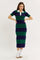 woman wearing a striped midi dress in green and navy with a white collar and short sleeves, paired with white sneakers