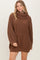 woman wearing a brown oversized cowl neck sweater dress with ribbed texture and long sleeves