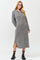 woman wearing a gray ribbed long sleeve midi dress with side slits and a lace-up neckline