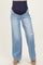 woman wearing a pair of light blue distressed maternity jeans with a navy blue over-the-bump panel