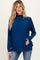 woman wearing a dark blue maternity sweater with a high neckline and relaxed fit, showing her baby bump