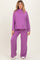 woman wearing a purple ribbed maternity lounge set with a relaxed fit top and wide-leg pants, showcasing a baby bump