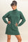 woman wearing a dark green oversized turtleneck sweater dress with long sleeves and a relaxed fit