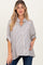 woman wearing a beige and white striped maternity shirt with a button-down front and short sleeves