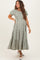 woman wearing a green and white striped maternity maxi dress with short sleeves and tiered ruffle hem, showing baby bump