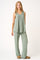 woman wearing a green tank top and matching wide-leg pajama pants, styled in a relaxed fit
