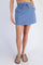 woman wearing a blue casual mini skirt with a drawstring waist and paired with brown sandals