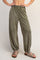 woman wearing olive green relaxed fit sweatpants with elastic waistband and tapered cuffs