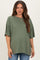 woman wearing a sage green oversized maternity t-shirt with short sleeves and a relaxed fit, showcasing her baby bump