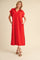 woman wearing a red short sleeve maxi dress with a collared neckline and side pockets