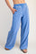 woman wearing light blue wide-leg sweatpants with an elastic waistband and side pockets