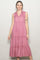 woman wearing a pink sleeveless maxi dress with a collared neckline and tiered ruffle details