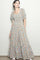 woman wearing a floral print maxi dress with square neckline and puff sleeves, standing against a light background