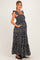 woman wearing a black floral maternity maxi dress with ruffle straps and pockets, showing her baby bump