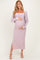 woman wearing a lavender ribbed maternity dress with side slits and a white trim, holding her baby bump