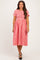 woman wearing a red and white gingham maternity dress with short sleeves and a fitted bodice