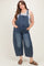 woman wearing a light blue maternity plus denim overall with a relaxed fit and pockets, styled with a gray tank top