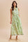 woman wearing a green floral sleeveless maxi dress with a tie waist detail