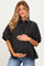 woman wearing a black and plaid short sleeve maternity shirt and holding her baby bump