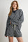 woman wearing a navy and white striped oversized pullover and matching shorts