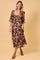 woman wearing a floral midi dress with short sleeves and a sweetheart neckline against a beige background
