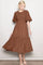 woman wearing a brown smocked bodice midi dress with flutter sleeves and a tiered skirt