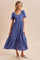 woman wearing a blue striped short sleeve maxi dress with a tiered skirt and a square neckline