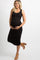 woman wearing a black maternity dress and an open knit cardigan, holding her baby bump