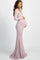 woman wearing a light pink off-shoulder maternity dress and holding her baby bump