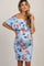 woman wearing a floral off-the-shoulder maternity dress, holding her baby bump