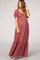 woman wearing a floral print maternity maxi dress with puff sleeves and a tiered hem, highlighting her baby bump