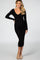 woman wearing a black ribbed maternity dress with a deep v-neckline and long sleeves, showing off her baby bump