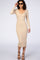 woman wearing a beige ribbed knit midi dress with long sleeves and a v-neckline, accessorized with sunglasses