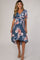 woman wearing a blue floral maternity wrap dress with short sleeves and a high-low hemline