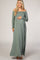woman wearing a sage green off-the-shoulder maternity maxi dress and holding her baby bump